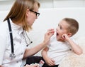 Doctor giving a child a pill Royalty Free Stock Photo