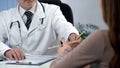 Doctor giving drug prescription to patient, qualified diagnosis and treatment Royalty Free Stock Photo