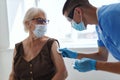 doctor giving an elderly woman a vaccine against coronavirus covid passport Royalty Free Stock Photo