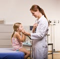 Doctor giving girl checkup in doctor office Royalty Free Stock Photo