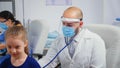 Doctor giving girl checkup in doctor office Royalty Free Stock Photo