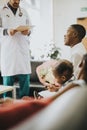 Doctor giving good news to relatives in the waiting room Royalty Free Stock Photo