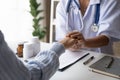 Doctor giving hope. Close up shot of young female physician leaning forward to smiling elderly lady patient holding her Royalty Free Stock Photo