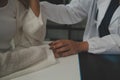 Doctor giving hope. Close up shot of young female physician leaning forward to smiling elderly lady patient holding her hand in Royalty Free Stock Photo