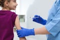 Doctor giving injection to little girl in hospital, closeup. Immunization concept Royalty Free Stock Photo