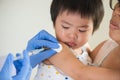 Doctor giving an injection vaccine to a girl. Little girl crying Royalty Free Stock Photo