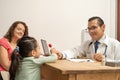 doctor giving a lollipop to a little girl as a reward. Pediatrician giving a candy to a child, building kid patient confidence Royalty Free Stock Photo