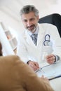 Doctor giving medical prescription to patient Royalty Free Stock Photo