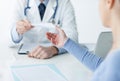 Doctor giving a medical prescription to the patient Royalty Free Stock Photo