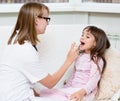 Doctor giving medical spray to little girl