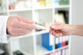 Doctor giving a medical thermometer his assistant Royalty Free Stock Photo