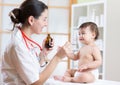 Doctor giving medicament to kid with a spoon, hospital Royalty Free Stock Photo