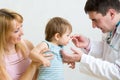 Doctor giving medicament to kid with a spoon Royalty Free Stock Photo