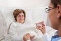 Doctor giving medication to senior patient