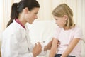 Doctor giving needle to young girl Royalty Free Stock Photo