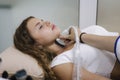 Doctor giving patient an ultrasound. Beautiful and young woman getting thyroid gland control Royalty Free Stock Photo