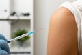 Doctor giving patient vaccine, flu shot. Doctor making a vaccination in the shoulder of patient Royalty Free Stock Photo