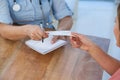 Doctor giving a prescription to her patient in medical office Royalty Free Stock Photo