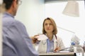 Doctor giving prescription to patient at desk in hospital Royalty Free Stock Photo