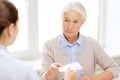 Doctor giving prescription to senior woman Royalty Free Stock Photo