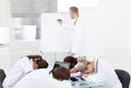 Doctor giving presentation to colleagues sleeping at desk Royalty Free Stock Photo