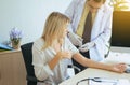 Doctor giving vaccine to female patient with injection or syringe in hospital room Royalty Free Stock Photo