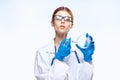 Doctor in glasses in a medical dressing gown holds a petri dish, laboratory glassware, medecine Royalty Free Stock Photo