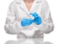 Doctor in gown and blue gloves holding empty glass ampoule Royalty Free Stock Photo