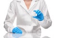 Doctor in gown and gloves holding empty ampoule against white Royalty Free Stock Photo