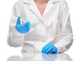 Doctor in gown and gloves holding syringe with blue drug Royalty Free Stock Photo