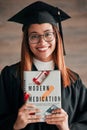 Doctor graduate, woman portrait and medical textbook of a young student happy from graduation. Learning book, happiness