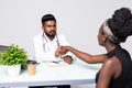 Doctor greeting patient at the hospital with a handshake at work desk Royalty Free Stock Photo