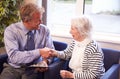 Doctor Greeting Senior Female Patient With Handshake