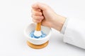 Doctor grinding blue pills with help of mortar and pestle Royalty Free Stock Photo