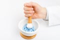 Doctor grinding pills with help of mortar and pestle Royalty Free Stock Photo