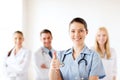 Doctor with group of medics showing thumbs up Royalty Free Stock Photo