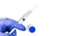 A doctor hand in a blue glove with a syringe and an ampoule of Covid-19 vaccine, a concept for an advertising flyer or banner with Royalty Free Stock Photo