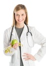 Doctor With Hand On Hip Holding Apple And Tape Measure Royalty Free Stock Photo
