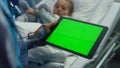 Doctor hand holding chroma key tablet computer device in hospital ward closeup. Royalty Free Stock Photo