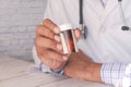 Doctor hand holding pill container with copy space Royalty Free Stock Photo