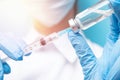 Doctor hand holding syringe and vaccine in blue gloves white coat. Disease injection concept Royalty Free Stock Photo