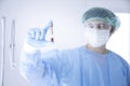 Doctor Hand holding test tube. Asian doctor holding Coronavirus COVID-19 bloods sample tube and nCoV-19 folder in lab. Selective Royalty Free Stock Photo