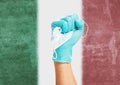 Doctor hand in medical glove with a mask on background flag of the Italy.
