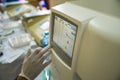 Doctor hand performing a blood test with hematological counter machine Royalty Free Stock Photo