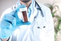 doctor hand in protective glass holding pill container Royalty Free Stock Photo