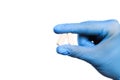 Doctor hand in sterile gloves holding  pill isolated on white background  close up view  - Image Royalty Free Stock Photo