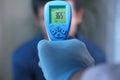 Hand holding inferred thermometer check temperature. Royalty Free Stock Photo