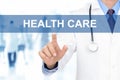 Doctor hand touching HEALTH CARE sign on virtual screen Royalty Free Stock Photo