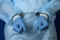 Doctor handcuffed, hands close-up, concept of medical corruption, bribery, crime