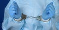 Doctor handcuffed, hands close-up, concept of medical corruption, bribery, crime